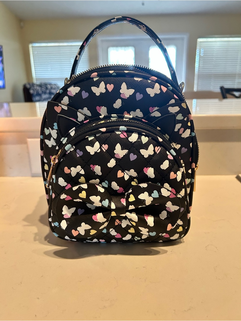 UnderOneSky Black Mini Backpack with Pastel Butterfly Print